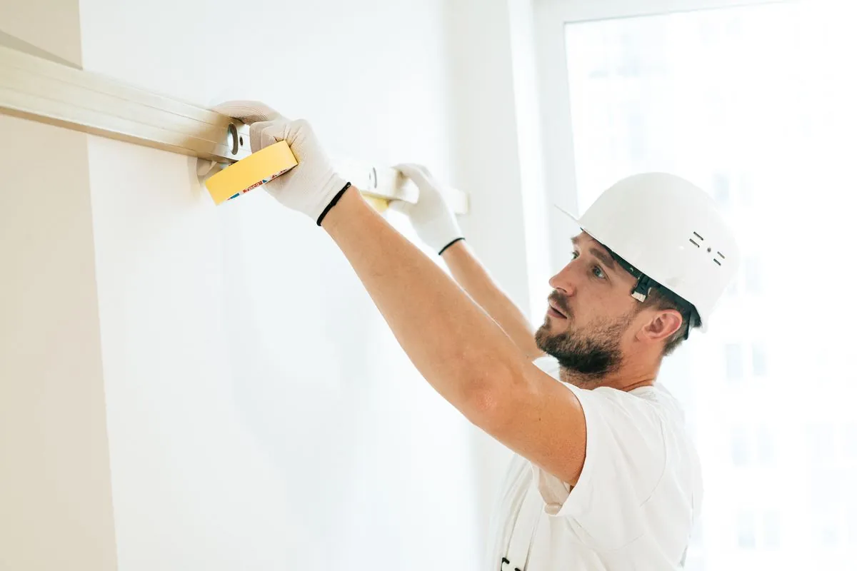 Inspector verifying finished work with a level